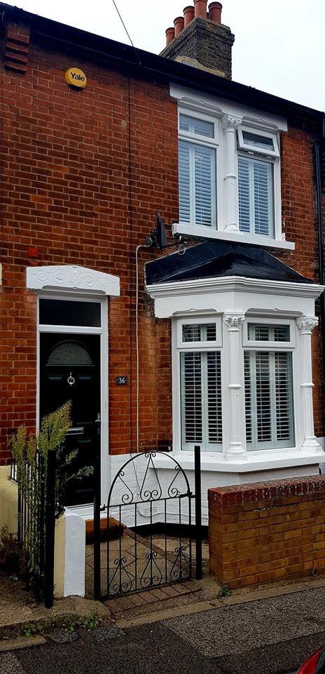 Black and white masonry on front of red brick house